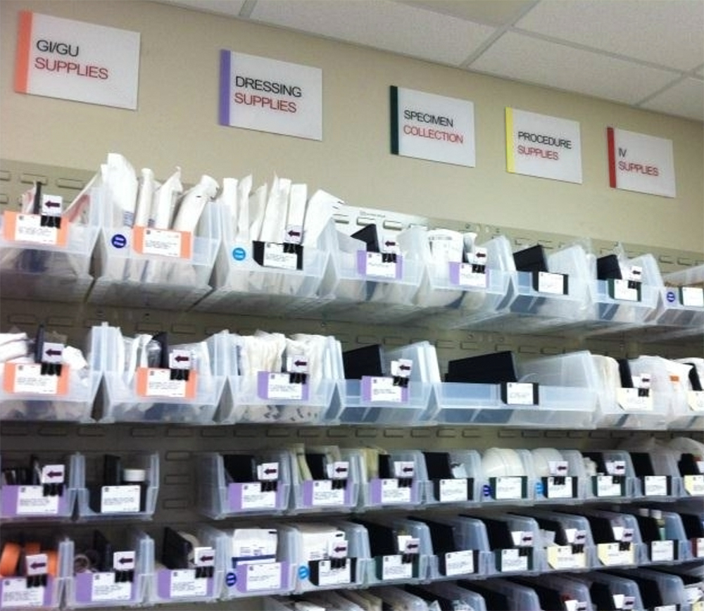 medical supplies organized in clear bins with color-coded bin labels